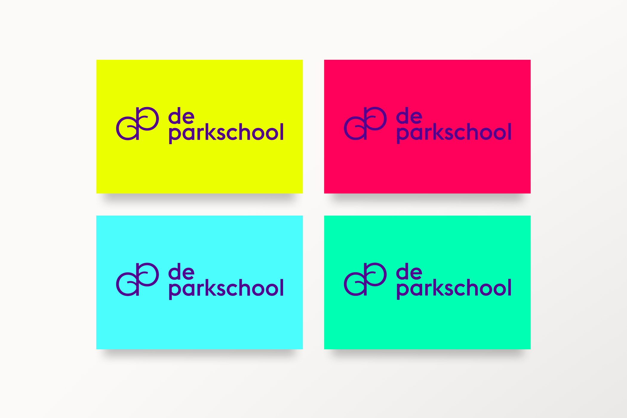 business cards in different colors with De Parkschool logo